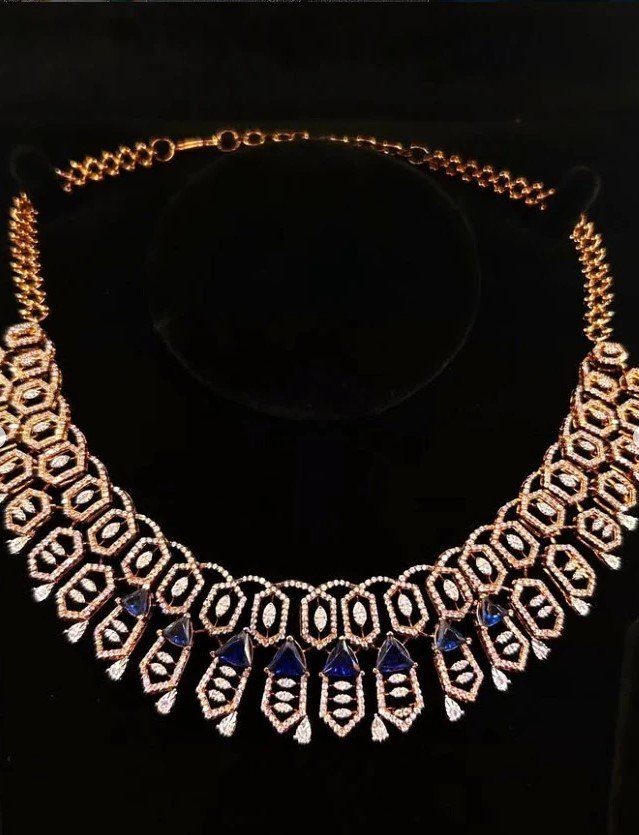 Intricate collar necklace with blue gemstone accents